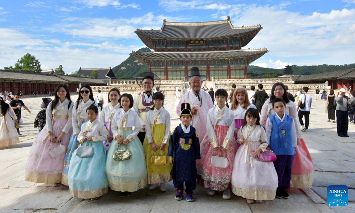 People wearing traditional Hanbok pose for photos as they visit the Gyeongbokgung Palace during the last day of the Chuseok holidays in Seoul, South Korea, Sept. 18, 2024. (Photo: Xinhua)