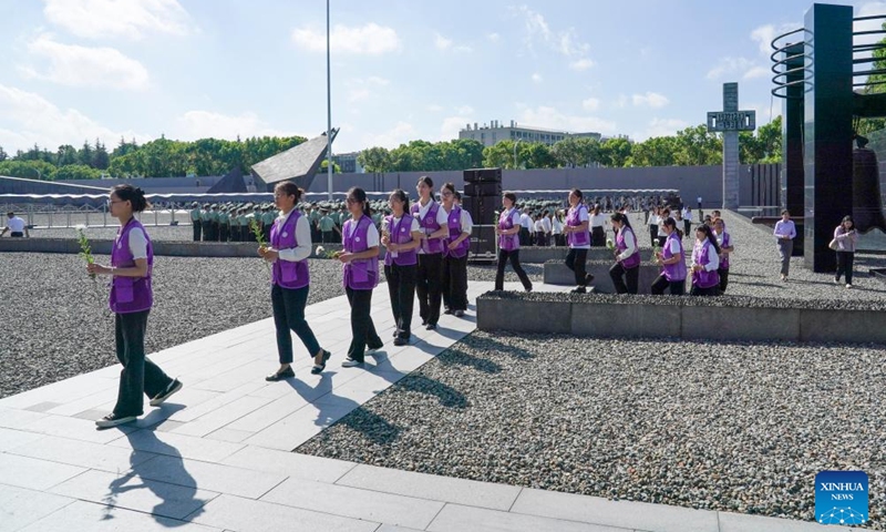 People line up to present flowers during an activity marking the 93rd anniversary of the September 18 Incident at the Memorial Hall of the Victims in Nanjing Massacre by Japanese Invaders in Nanjing, east China's Jiangsu Province, Sept. 18, 2024. People from Nanjing and other places commemorated the 93rd anniversary of September 18 Incident, which marked the outbreak of Japan's large-scale invasion of China. (Photo: Xinhua)