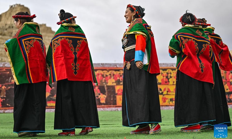 Local residents chat after performing Xuan Dance near the ruins of the Guge Kingdom in Zanda County of Ngari Prefecture, southwest China's Xizang Autonomous Region, Sept. 11, 2024. The dance is a Tibetan cultural heritage from the ancient Guge Kingdom that mixes speech, singing and dancing. It was inscribed into the national intangible cultural heritage list in 2008. (Photo: Xinhua)