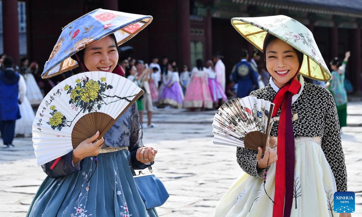 People wearing traditional Hanbok pose for photos as they visit the Gyeongbokgung Palace during the last day of the Chuseok holidays in Seoul, South Korea, Sept. 18, 2024. (Photo: Xinhua)