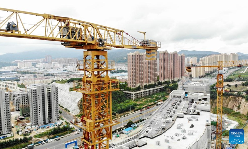 An aerial drone photo shows an unmanned remote tower crane during a demonstration at a construction site in Huangdao District of Qingdao, east China's Shandong Province, Sept. 18, 2024. China Construction Eighth Engineering Division launched its self-developed new generation of unmanned remote tower crane in Qingdao on Wednesday. (Photo: Xinhua)