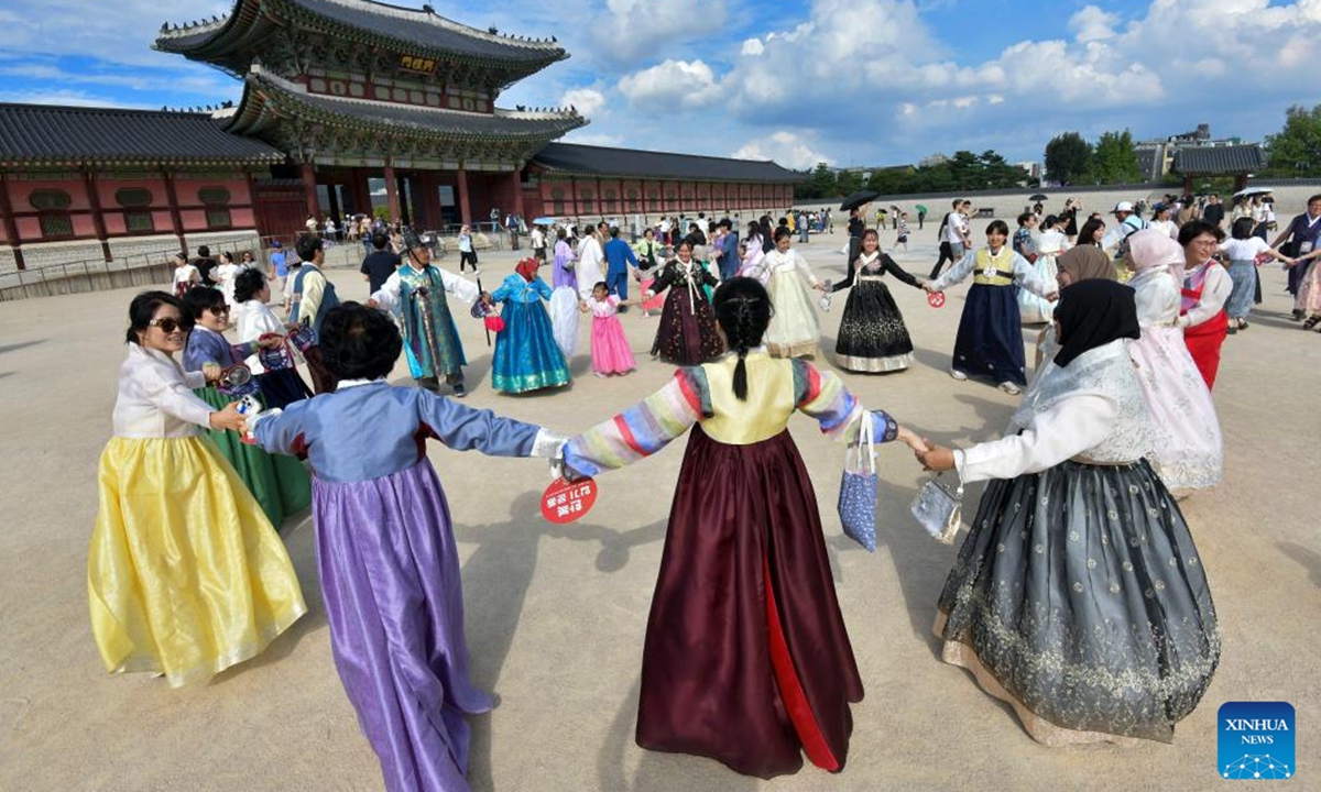 People wearing traditional Hanbok dance as they visit the Gyeongbokgung Palace during the last day of the Chuseok holidays in Seoul, South Korea, Sept. 18, 2024. (Photo: Xinhua)