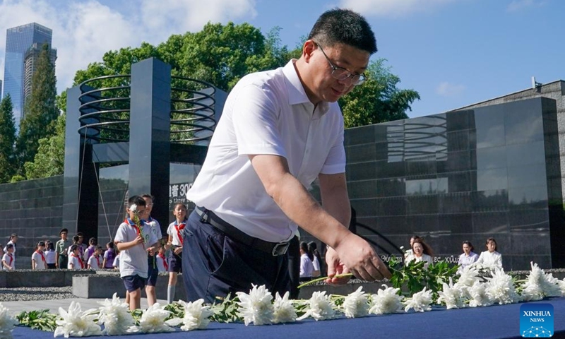 People present flowers during an activity marking the 93rd anniversary of the September 18 Incident at the Memorial Hall of the Victims in Nanjing Massacre by Japanese Invaders in Nanjing, east China's Jiangsu Province, Sept. 18, 2024. People from Nanjing and other places commemorated the 93rd anniversary of September 18 Incident, which marked the outbreak of Japan's large-scale invasion of China. (Photo: Xinhua)