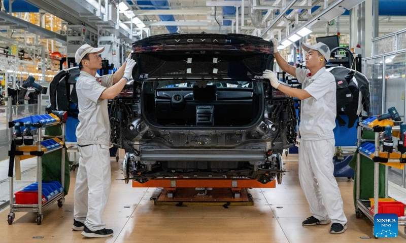 Workers install the rear lights to a vehicle at an assembly line of Dongfeng Motor Corporation in Wuhan, central China's Hubei Province, Sept. 6, 2024.  (Photo: Xinhua)