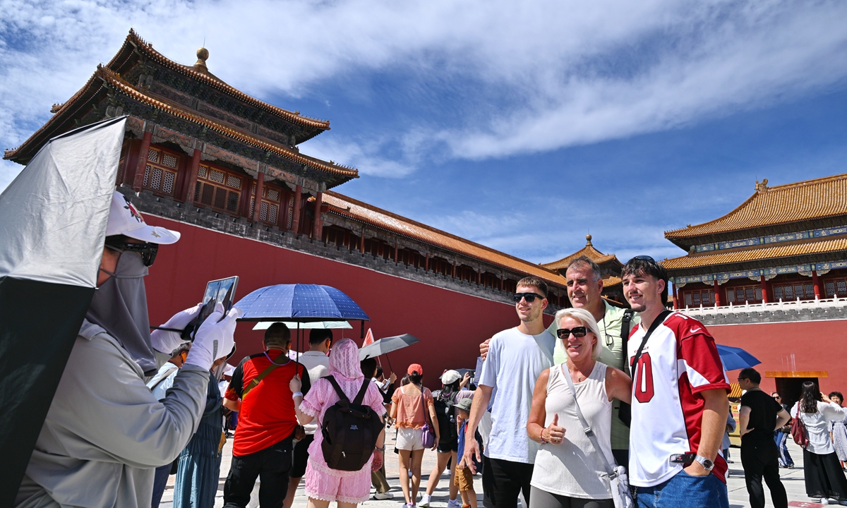 Foreign tourists have a group photo taken at the Palace Museum in Beijing on September 5, 2024.  Photo: VCG