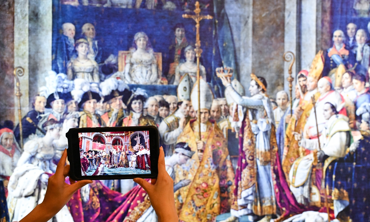 A visitor takes a photo at the Notre-Dame de Paris: The Augmented Exhibition at the National Museum of China in Beijing on September 11, 2024. Photo: VCG