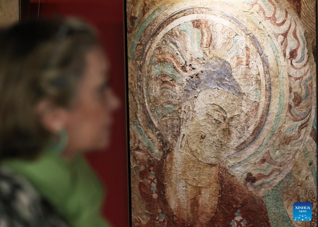 A woman visits the Silk Road Danqing, an exhibition of copies of cave temple mural paintings along the ancient Silk Road at the China Cultural Center in Paris, France, Sept. 18, 2024. The exhibition will last till Sept. 24, 2024. (Photo: Xinhua)