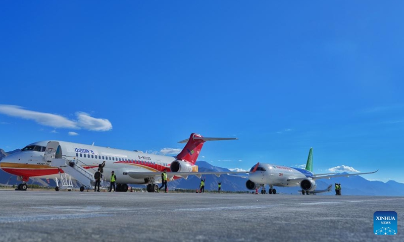 A C919 passenger aircraft (R) is parked next to an ARJ21 aircraft at Lhasa Gonggar International Airport in Lhasa, southwest China's Xizang Autonomous Region, Sept. 19, 2024. China's homegrown C919 jetliner, developed by the Commercial Aircraft Corporation of China (COMAC), completed a flight from southwest China's Sichuan Province to the neighboring Xizang Autonomous Region on Thursday, marking the aircraft's first landing in Xizang. (Photo: Xinhua)