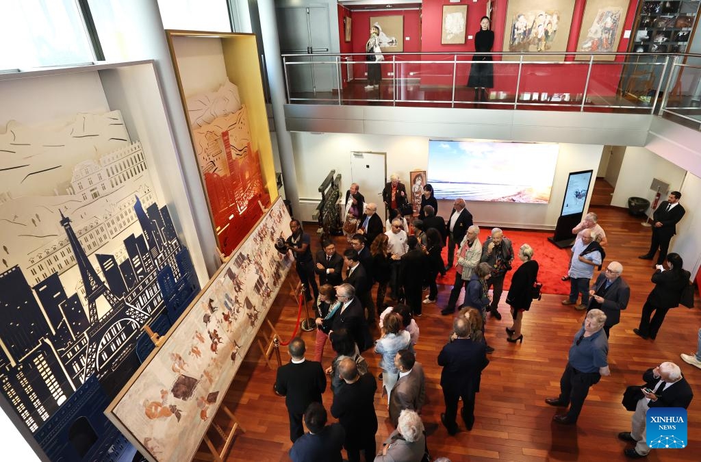 Guests visit the Silk Road Danqing, an exhibition of copies of cave temple mural paintings along the ancient Silk Road at the China Cultural Center in Paris, France, Sept. 18, 2024. The exhibition will last till Sept. 24, 2024. (Photo: Xinhua)