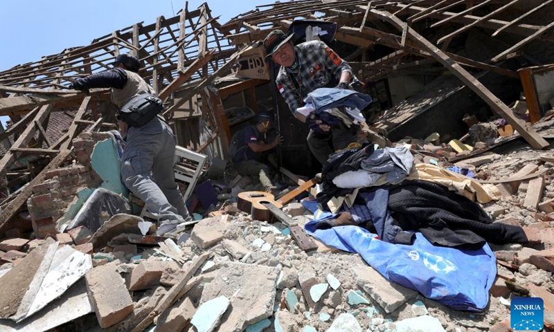 This photo provided by Indonesia's National Disaster Management Agency (BNPB) shows rescuers collecting useable items from damaged houses after an earthquake struck Kertasari village in Bandung regency, West Java, Indonesia, Sept. 19, 2024. A shallow earthquake measuring 4.9 on the Richter scale struck Indonesia's West Java province on Wednesday, killing one person and injuring at least 82 others, officials reported. (Photo: Xinhua)