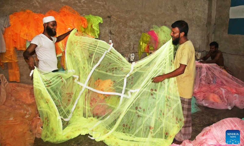 Vendors arrange mosquito nets at a market in Dhaka, Bangladesh, Sept. 18, 2024. The June-September monsoon period is the peak season for dengue fever in Bangladesh, a high-risk country prone to the mosquito-borne disease. Amidst the outbreak of dengue fever, the demand for mosquito nets has surged dramatically. (Photo: Xinhua)