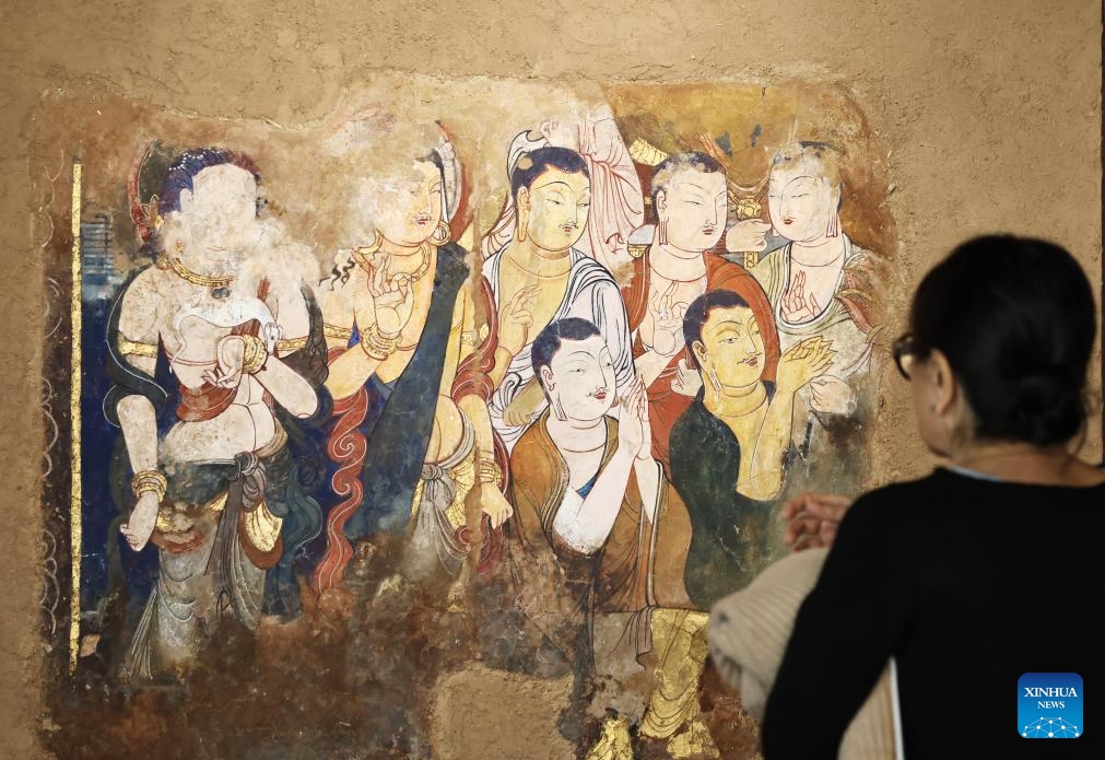 A woman visits the Silk Road Danqing, an exhibition of copies of cave temple mural paintings along the ancient Silk Road at the China Cultural Center in Paris, France, Sept. 18, 2024. The exhibition will last till Sept. 24, 2024. (Photo: Xinhua)