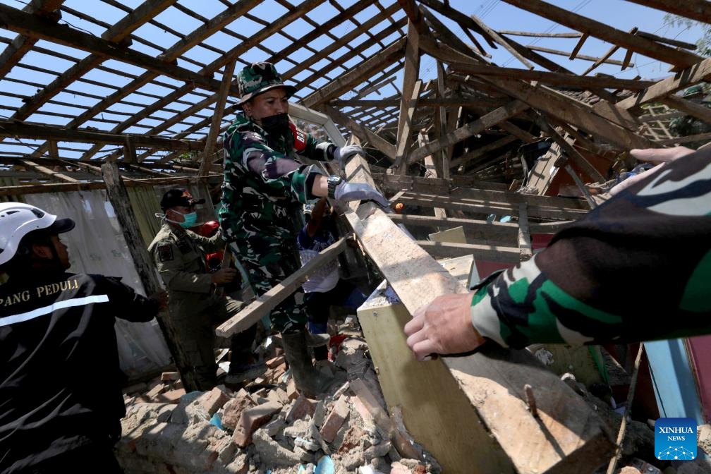 This photo provided by Indonesia's National Disaster Management Agency (BNPB) shows rescuers collecting useable items from damaged houses after an earthquake struck Kertasari village in Bandung regency, West Java, Indonesia, Sept. 19, 2024. A shallow earthquake measuring 4.9 on the Richter scale struck Indonesia's West Java province on Wednesday, killing one person and injuring at least 82 others, officials reported. (Photo: Xinhua)