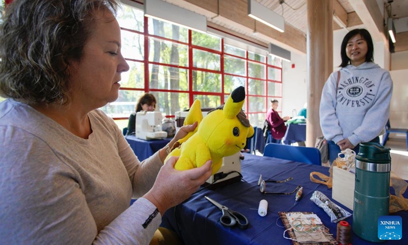 A doll doctor checks a stuffed toy during the Teddy Bear Repair Fair in Richmond, British Columbia, Canada, Sept. 21, 2024.

The one-day event offered a service where people brought their worn or damaged dolls to be fixed. By restoring these beloved items, the event aimed to promote sustainability, reduce waste, and help people preserve cherished memories. (Photo: Xinhua)