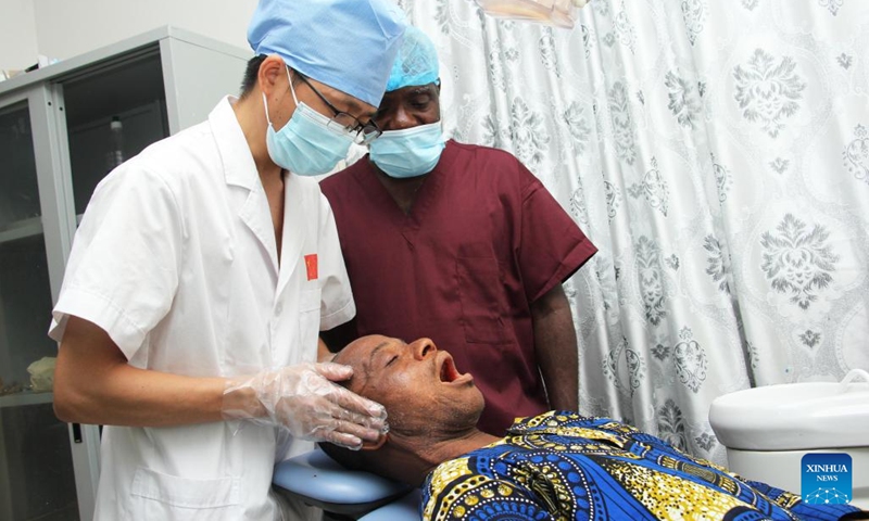 A doctor of the 27th batch of Chinese medical team checks a patient during a free dental clinic service event at a hospital in Lokossa, Benin, Sept. 20, 2024. (Photo: Xinhua)