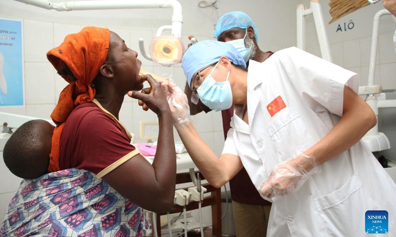 A doctor of the 27th batch of Chinese medical team checks a patient during a free dental clinic service event at a hospital in Lokossa, Benin, Sept. 20, 2024. (Photo: Xinhua)