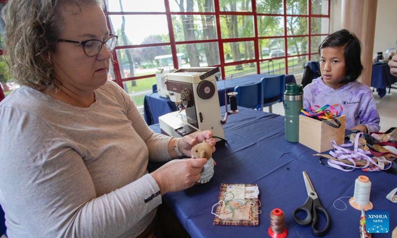 A doll doctor restores a damaged stuffed doll during the Teddy Bear Repair Fair in Richmond, British Columbia, Canada, Sept. 21, 2024.

The one-day event offered a service where people brought their worn or damaged dolls to be fixed. By restoring these beloved items, the event aimed to promote sustainability, reduce waste, and help people preserve cherished memories.  (Photo: Xinhua)