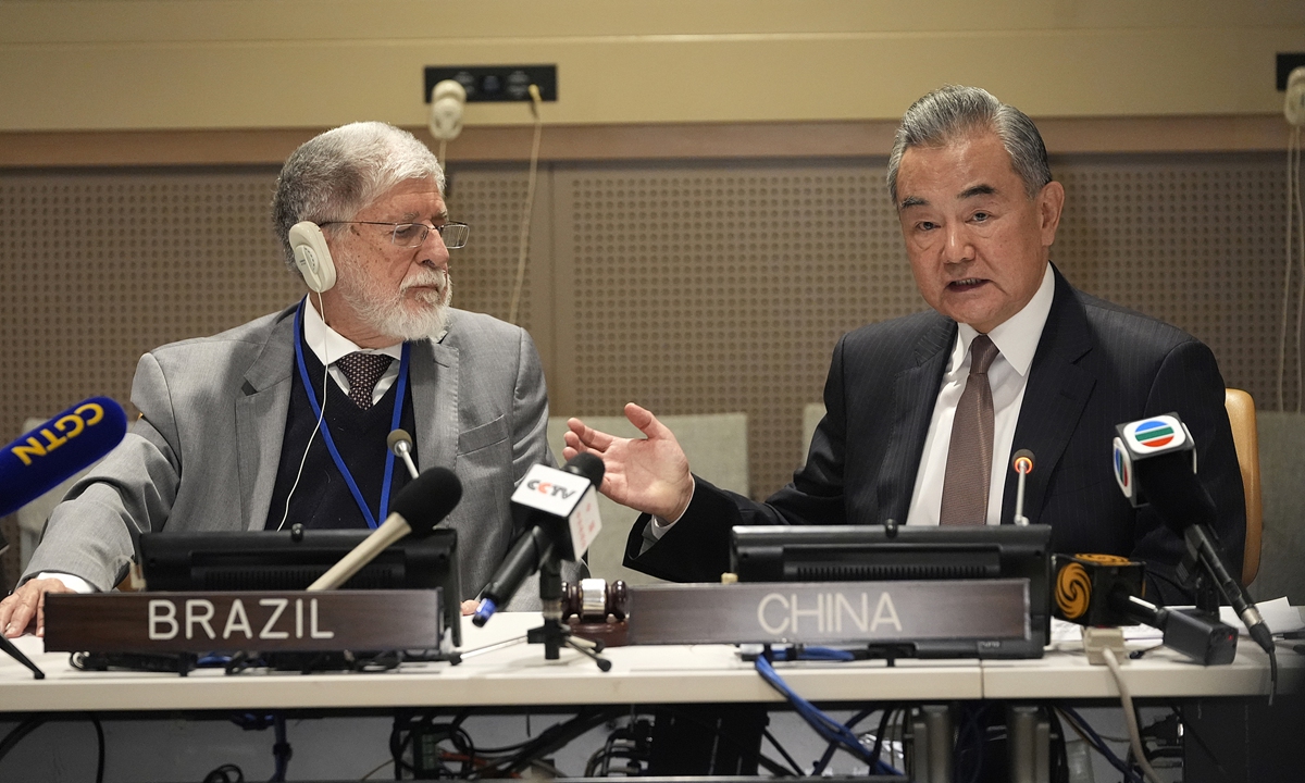 Chinese Foreign Minister Wang Yi, also a member of the Political Bureau of the Communist Party of China Central Committee, speaks at a joint press conference with Celso Amorim, special advisor to the President of Brazil, after a ministerial meeting of the newly launched 