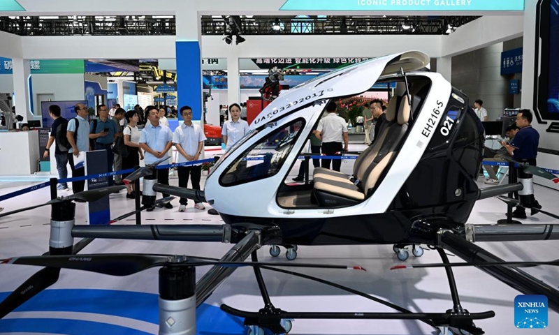 Visitors learn about an electric vertical takeoff and landing aircraft at the 2024 World Manufacturing Convention in Hefei, east China's Anhui Province, Sept. 20, 2024. The 2024 World Manufacturing Convention opened Friday in Hefei, capital of east China's Anhui Province, highlighting the latest products and innovations in the manufacturing sector. (Photo: Xinhua)