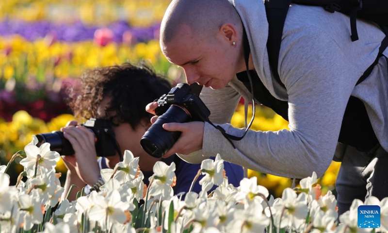 Visitors take photos of flowers at the Floriade festival in Canberra, Australia, on Sept. 20, 2024. The 37th edition of the annual flower and entertainment festival Floriade launched on Sept. 14 in Canberra's Commonwealth Park. (Photo: Xinhua)