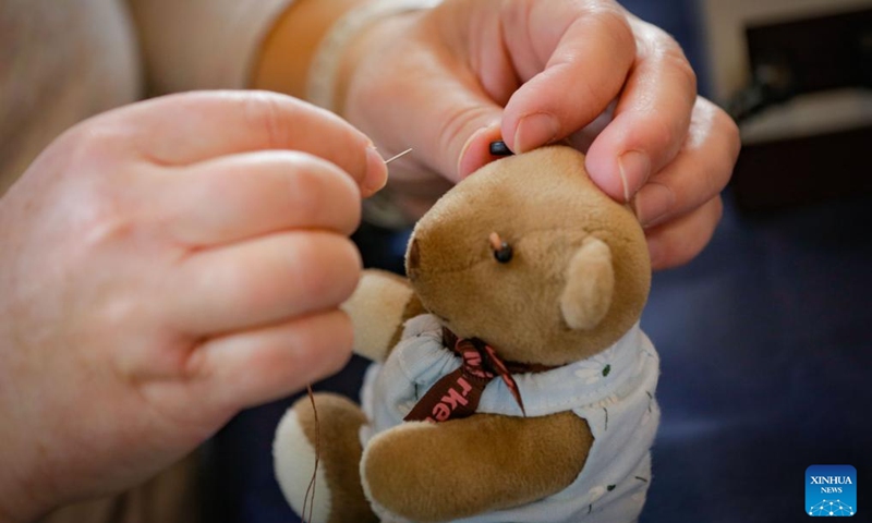 A doll doctor restores a damaged stuffed doll during the Teddy Bear Repair Fair in Richmond, British Columbia, Canada, Sept. 21, 2024.

The one-day event offered a service where people brought their worn or damaged dolls to be fixed. By restoring these beloved items, the event aimed to promote sustainability, reduce waste, and help people preserve cherished memories.  (Photo: Xinhua)