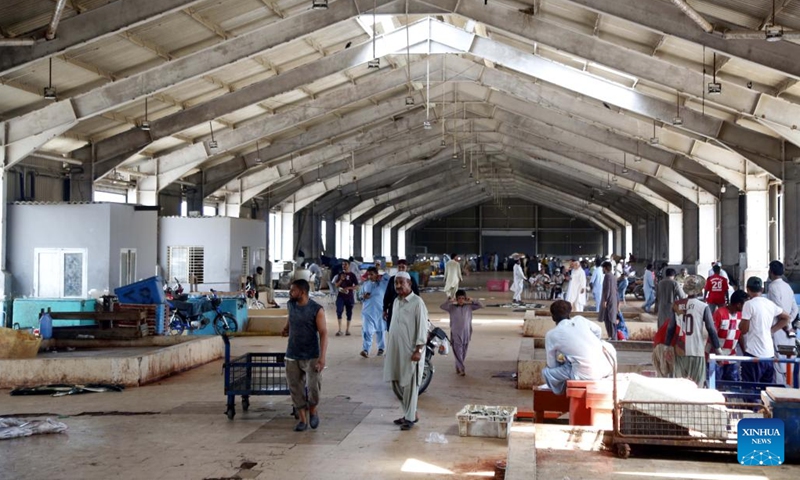 People buy fish in a fish market in southwest Pakistan's Gwadar on Sept. 19, 2024. (Photo: Xinhua)