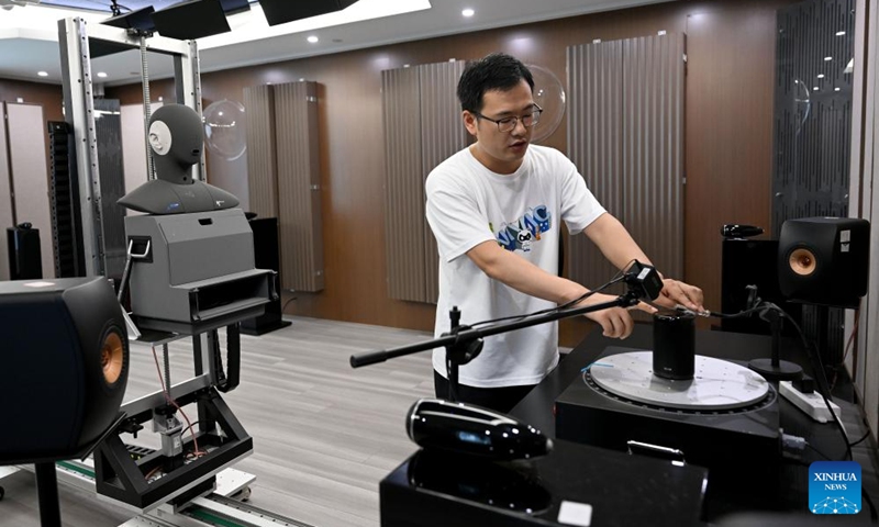 A staff member of the National Intelligent Voice Innovation Center tests on an intelligent speaker at the China Speech Valley in Hefei City, east China's Anhui Province, Sept. 20, 2024. China Speech Valley in Hefei City, the Vision Valley of China in Wuhu City and China Sensor Valley in Bengbu City, are three key demonstration zones for the artificial intelligence (AI) industry in Anhui Province. (Photo: Xinhua)