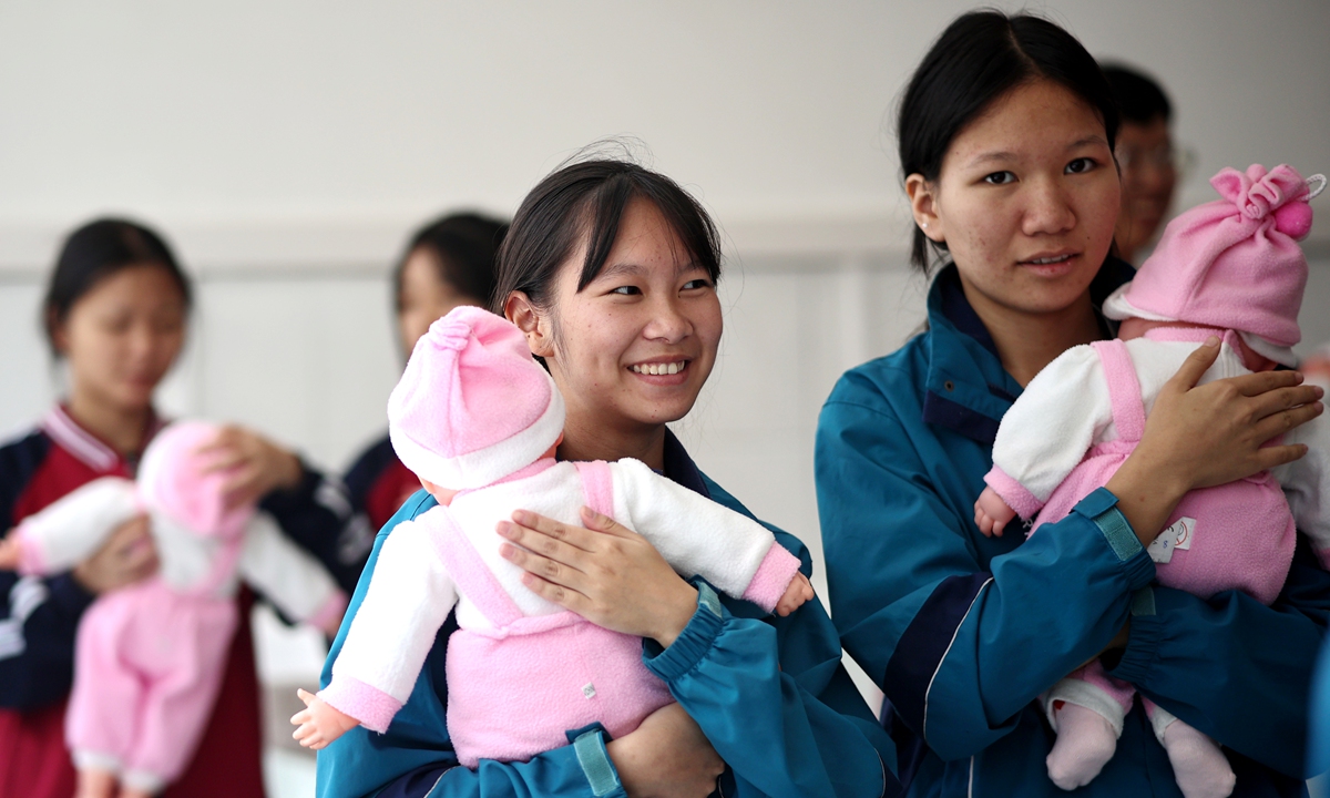 Students of an early childhood care program learn childcare skills at a vocational school in Huaihua, Central China's Hunan Province, on September 23, 2024. China has taken active measures to boost the country's demographic development. The latest statistics show an increase in the number of newborns during the first half of 2024 in multiple localities across China. 
Photo: VCG