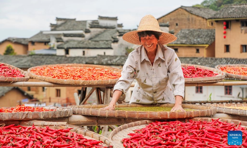 A villager airs crops at Yangchan Village in Huangshan City, east China's Anhui Province, Sept. 22, 2024. This Sunday marks the seventh Chinese farmers' harvest festival. (Photo: Xinhua)