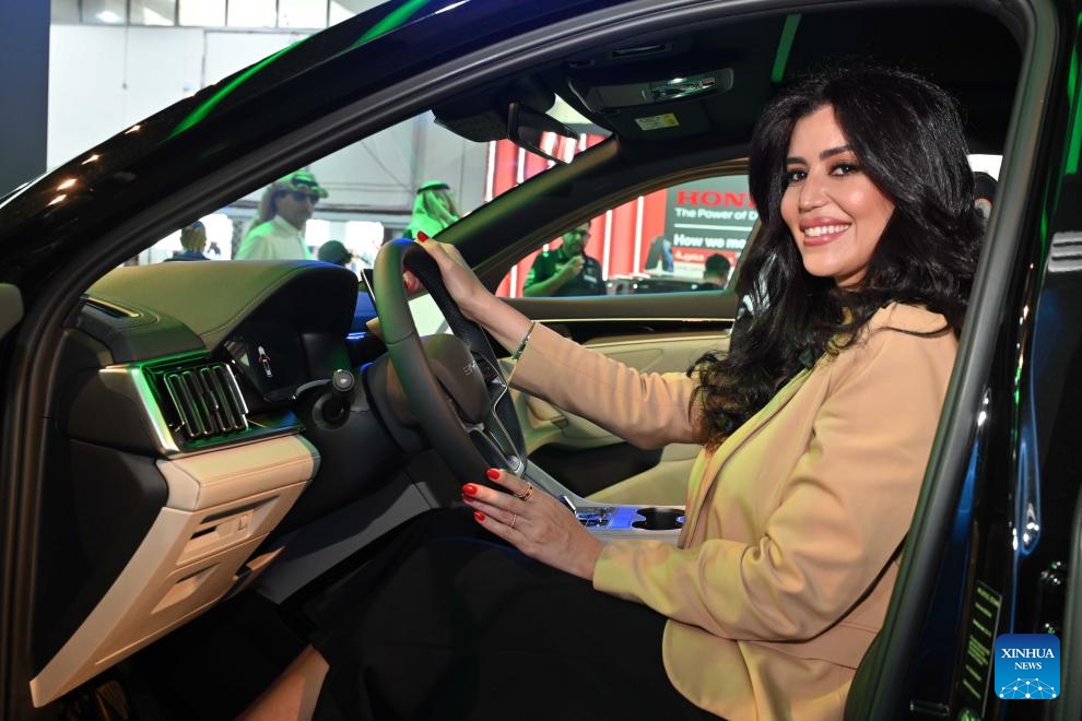 A woman poses for photos inside a BYD vehicle at the Auto World Show in Hawalli Governorate, Kuwait, Sept. 23, 2024. The six-day event kicked off here Monday. (Photo: Xinhua)