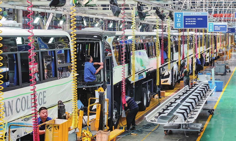 Workers catch up on the production of passenger buses for domestic and international orders on September 24, 2024 in Yangzhou, East China's Jiangsu Province. The local district has ramped up efforts to boost its industrial upgrading and transformation, aiming to build vehicle and parts industrial and supply chains to promote regional development. 
Photo: VCG