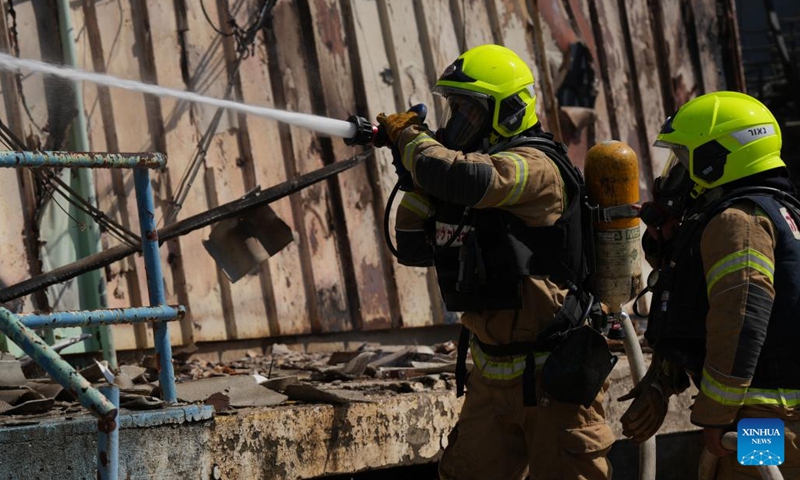 Firefighters work to extinguish a fire on a warehouse hit by a rocket from Lebanon, in Kiryat Shmona, northern Israel, on Sept. 24, 2024. The Israeli military reported that Hezbollah had resumed rocket fire on northern Israel, launching about 95 rockets since early Tuesday, with dozens landing in the cities of Kiryat Shmona, Nahariya, Afula, Nazareth, and Migdal Ha'emek. (Photo: Xinhua)