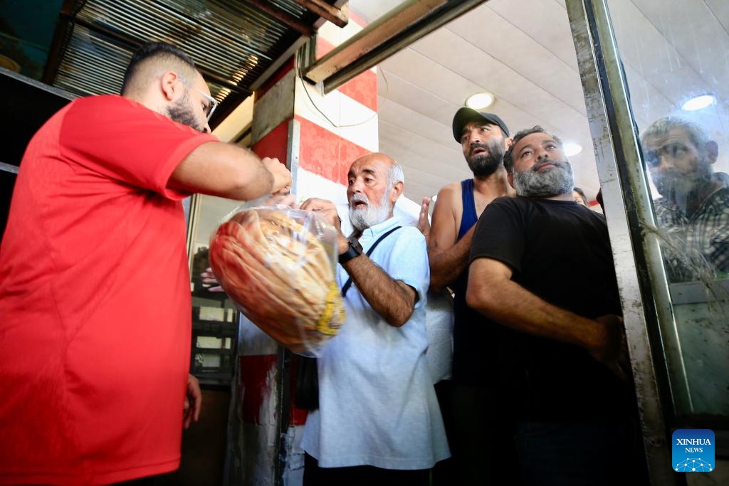 Displaced people line up to buy bread in Sidon, Lebanon, on Sept. 24, 2024. Israeli Prime Minister Benjamin Netanyahu warned the Lebanese people on Tuesday that attacks on Lebanon will continue. He reiterated a call made on Monday for civilians to evacuate homes where Hezbollah has allegedly stored missiles (Photo: Xinhua)