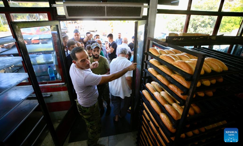 Displaced people line up to buy bread in Sidon, Lebanon, on Sept. 24, 2024. Israeli Prime Minister Benjamin Netanyahu warned the Lebanese people on Tuesday that attacks on Lebanon will continue. He reiterated a call made on Monday for civilians to evacuate homes where Hezbollah has allegedly stored missiles. (Photo: Xinhua)