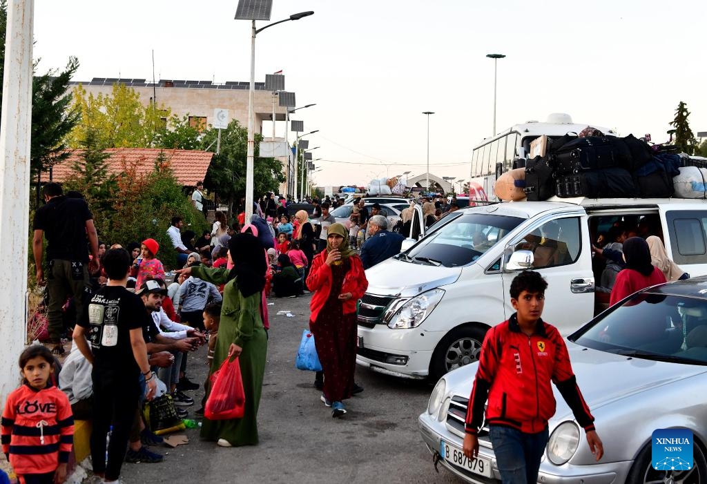 People fleeing from Lebanon are seen at the Jdeidat Yabous border crossing in the countryside of Damascus, Syria, on Sept. 24, 2024. Syrian authorities are facilitating entry at border crossings for both Lebanese and returning Syrian nationals, local media outlet Al-Watan Online reported on Tuesday. (Photo: Xinhua)