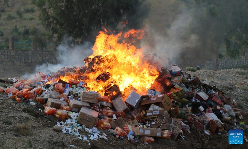 Expired and low-quality medicine and food items are set on fire in eastern Khost province, Afghanistan, Sept. 23, 2024. (Photo: Xinhua)