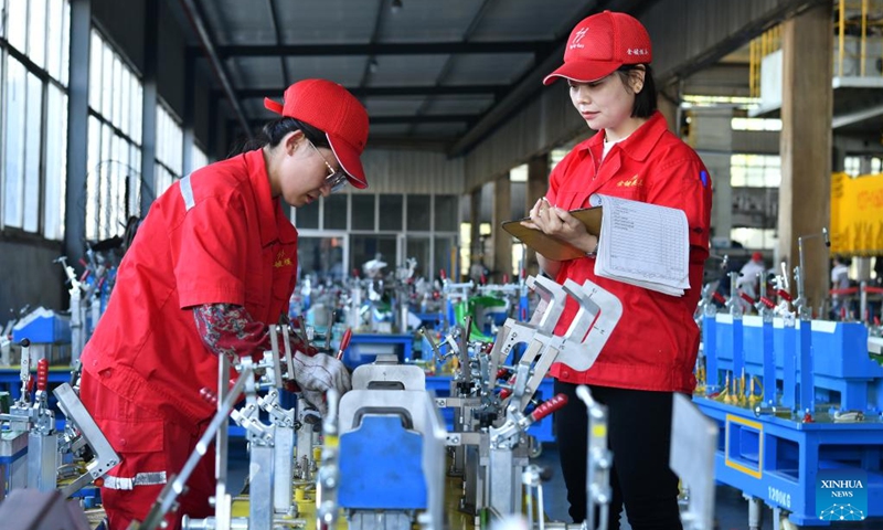 Workers check product quality at a mold company in Botou, north China's Hebei Province, Sept. 24, 2024. As one of the old industry bases in the central south of Hebei, Botou is dubbed origin of casting industry in the country, home to 322 casting companies, and boasting an annual output of 24.7 billion yuan (about 3.52 billion U.S. dollars) by clustered players there. Recent years have witnessed their manufacturing processes converted to green and environmental friendly ones. (Photo: Xinhua)