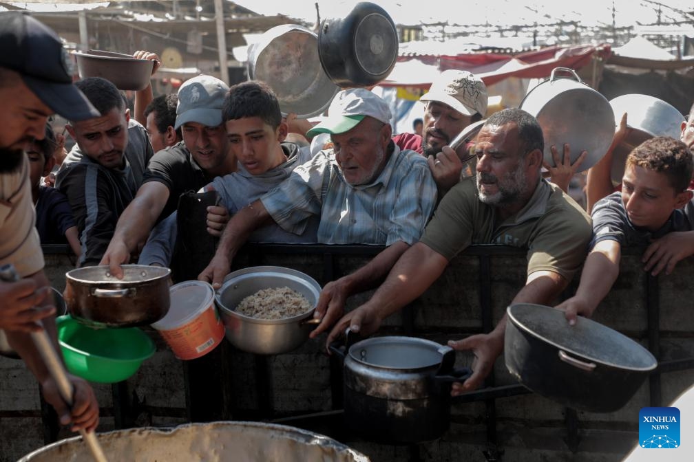 Palestinian people receive food relief in the southern Gaza Strip city of Khan Younis, on Sept. 24, 2024. (Photo: Xinhua)