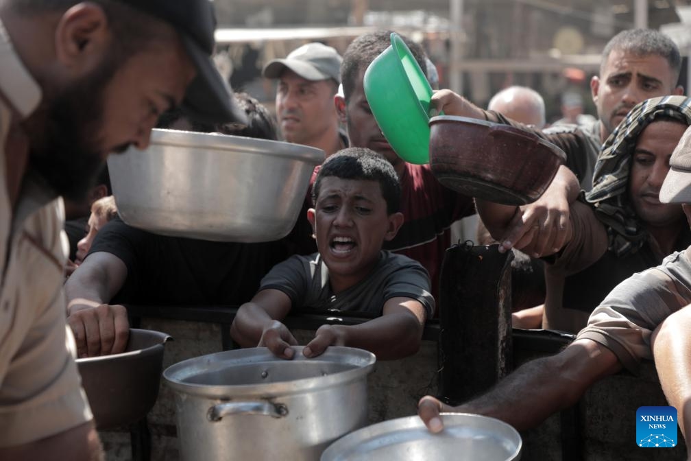 Palestinian people receive food relief in the southern Gaza Strip city of Khan Younis, on Sept. 24, 2024. (Photo: Xinhua)