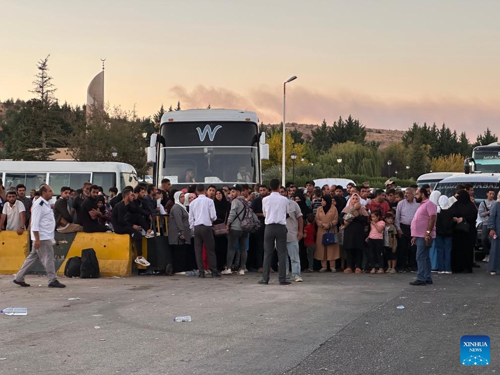 People gather at the Jdeidat Yabous border crossing in the countryside of Damascus, Syria, Sept. 25, 2024. Thousands of Lebanese and Syrian families fled Lebanon for Syria as Israeli airstrikes continued, said the Office of the United Nations High Commissioner for Refugees (UNHCR) on Wednesday. (Photo: Xinhua)