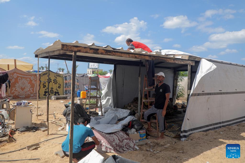 People build a tent in a temporary shelter in the southern Gaza Strip city of Khan Younis, on Sept. 23, 2024. If international organizations cannot provide us with tents, we face a harsh winter that could lead to the deaths of refugees due to the cold and lack of shelter, Om Fadi said (Photo: Xinhua)