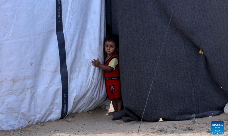 A boy is seen in a temporary shelter in the southern Gaza Strip city of Khan Younis, on Sept. 23, 2024. If international organizations cannot provide us with tents, we face a harsh winter that could lead to the deaths of refugees due to the cold and lack of shelter, Om Fadi said. (Photo: Xinhua)