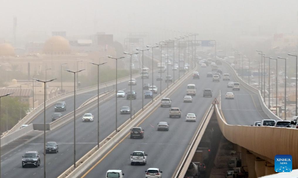 Cars drive on a road during a strong dust storm in Farwaniya Governorate, Kuwait on Sept. 26, 2024. (Photo: Xinhua)