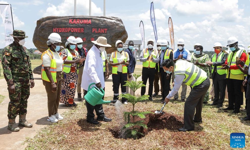 Ugandan President Yoweri Museveni and Chinese Ambassador to Uganda Zhang Lizhong plant a tree together at the Karuma dam site in Kiryandongo, Uganda, Sept. 26, 2024. Ugandan President Yoweri Museveni has commissioned the Chinese-built 600-megawatt Karuma Hydropower Station and the Karuma Interconnection Project in the midwestern Ugandan district of Kiryandongo. (Photo: Xinhua)