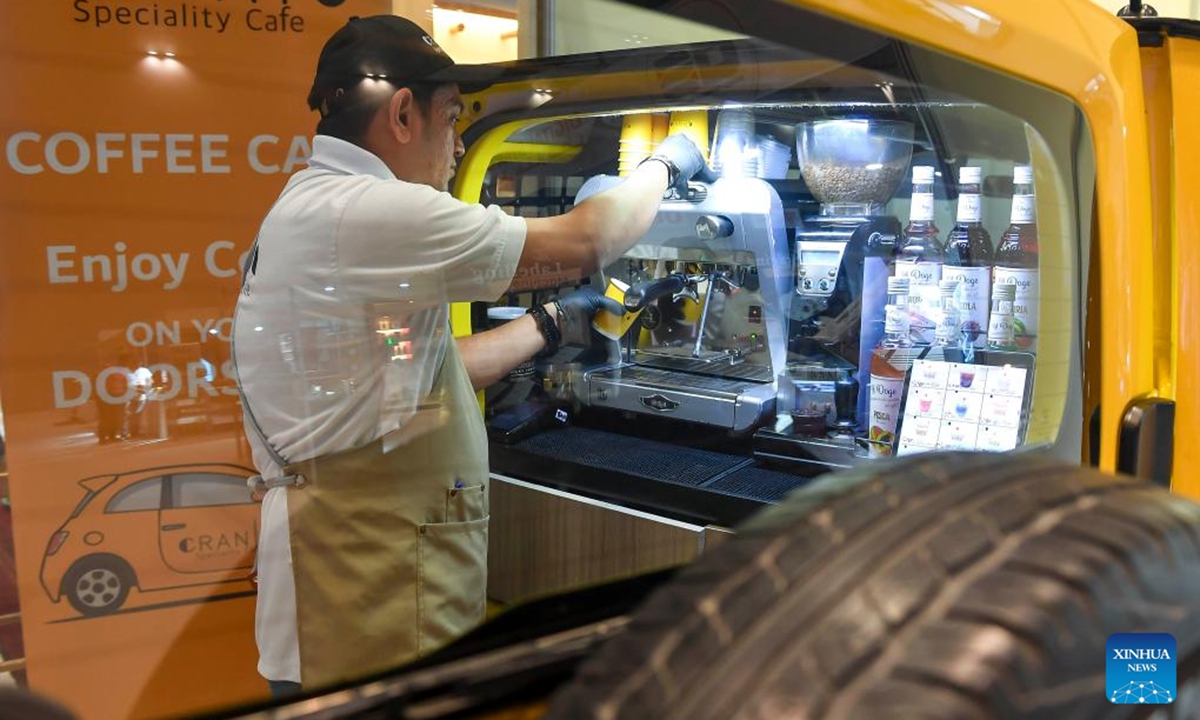 A worker operates a coffee maker during the 2nd edition of Doha International Coffee Exhibition 2024 in Doha, Qatar, Sept. 27, 2024. The event is held here from Sept. 26 to 28. (Photo: Xinhua)