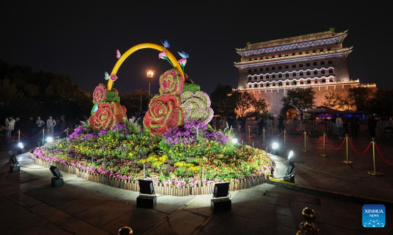 Tourists visit the Qianmen Street and the Zhengyang Gate arrow tower in Beijing, capital of China, Sept. 26, 2024. Beijing will activate over 2,800 nighttime illumination facilities from Sept. 29 to Oct. 7 to mark the 75th anniversary of the founding of the People's Republic of China. Upgraded illumination effects will be applied to landmarks along the Beijing Central Axis such as the Yongding Gate and the Bell and Drum Towers for the upcoming National Day holiday.  (Photo: Xinhua)