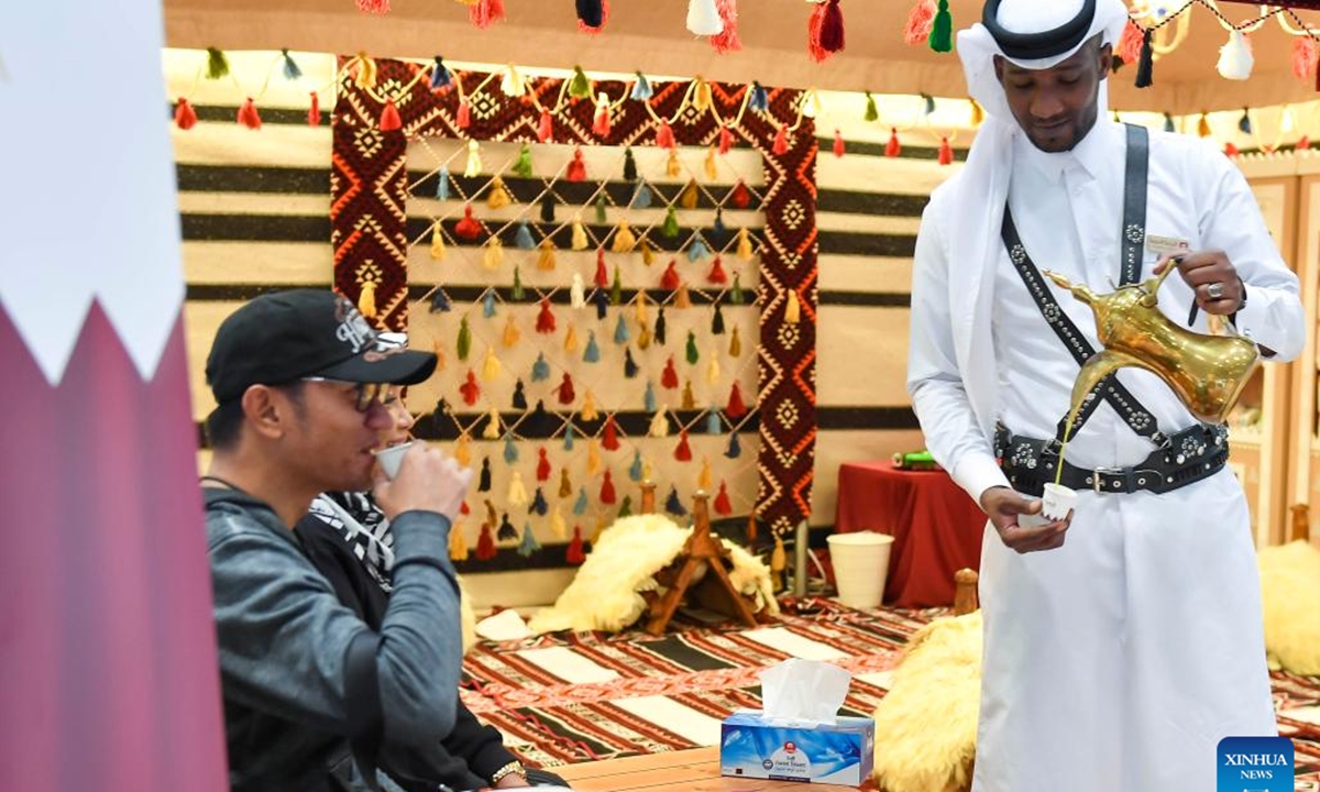 A man serves Arabic coffee to a visitor during the 2nd edition of Doha International Coffee Exhibition 2024 in Doha, Qatar, Sept. 27, 2024. The event is held here from Sept. 26 to 28.  (Photo: Xinhua)