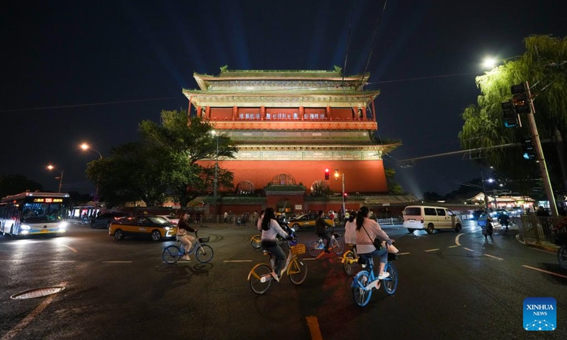 Tourists visit the Drum Tower in Beijing, capital of China, Sept. 26, 2024. Beijing will activate over 2,800 nighttime illumination facilities from Sept. 29 to Oct. 7 to mark the 75th anniversary of the founding of the People's Republic of China. Upgraded illumination effects will be applied to landmarks along the Beijing Central Axis such as the Yongding Gate and the Bell and Drum Towers for the upcoming National Day holiday.  (Photo: Xinhua)