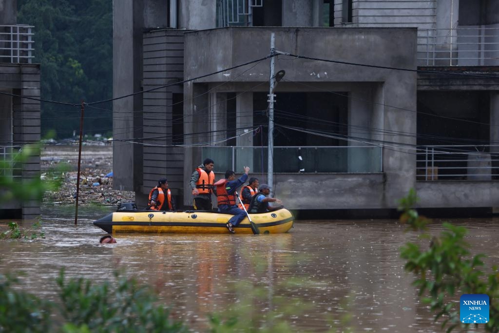 Rescuers sail in an inflatable boat in a flooded neighborhood in Lalitpur, Nepal, Sept. 28, 2024. Floods and landslides triggered by incessant rainfalls in Nepal have claimed at least 59 lives and injured 36 others by Saturday afternoon, police said. (Photo: Xinhua)