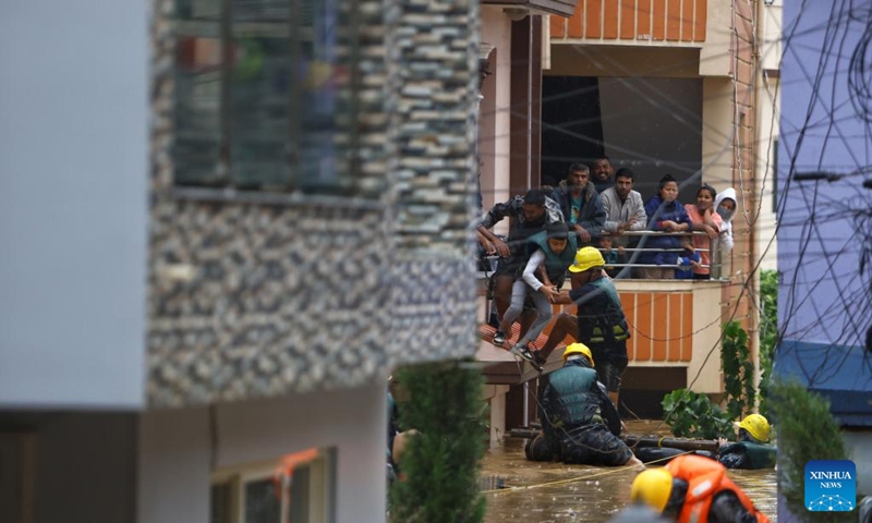 Rescuers evacuate residents trapped by flood in a neighborhood in Lalitpur, Nepal, Sept. 28, 2024. Floods and landslides triggered by incessant rainfalls in Nepal have claimed at least 59 lives and injured 36 others by Saturday afternoon, police said. (Photo: Xinhua)